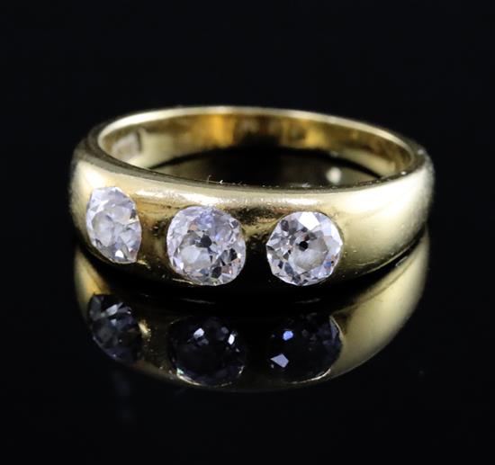 An 18ct gold and gypsy set three stone diamond ring, size O.